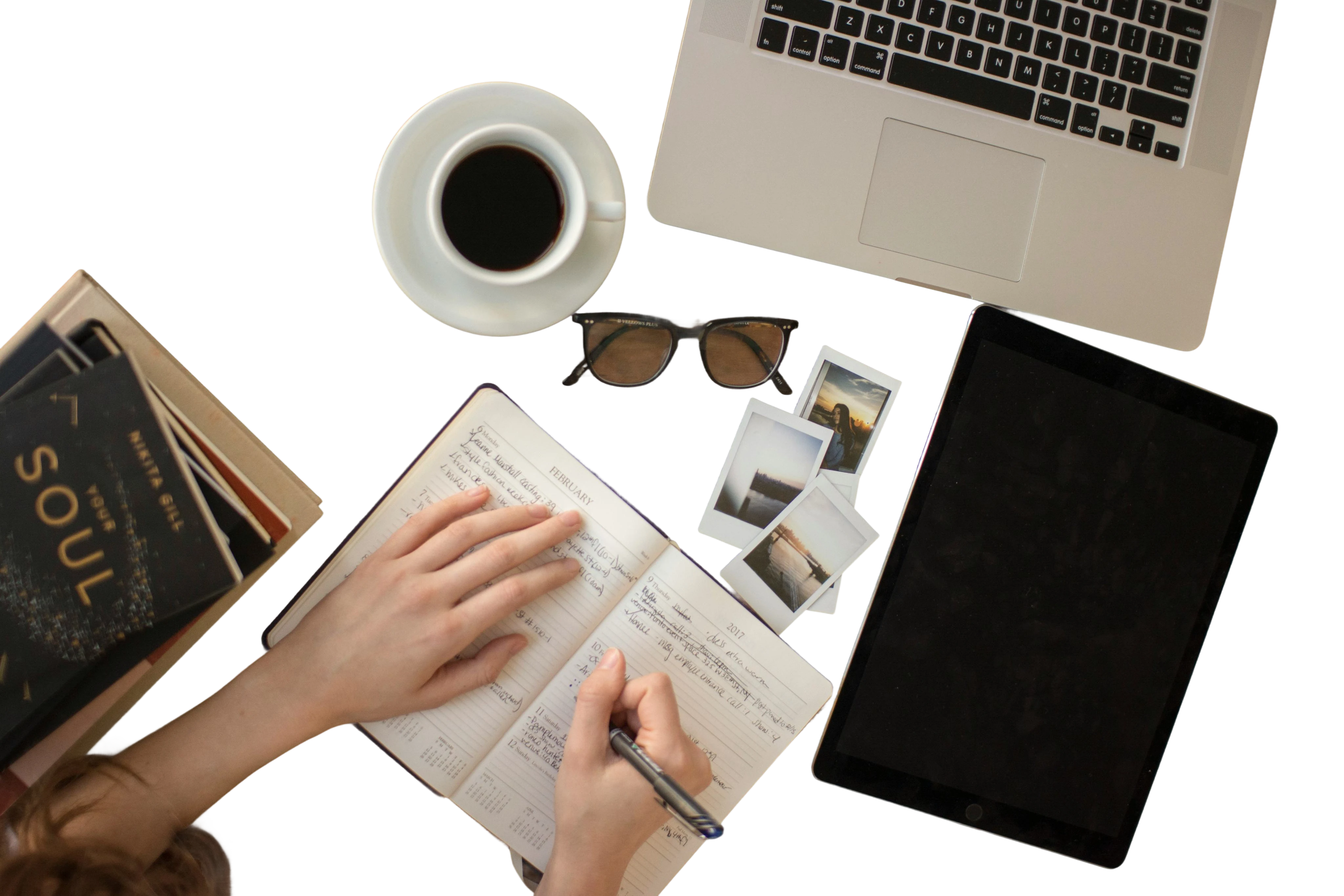 A student working at a desk with a laptop and study materials