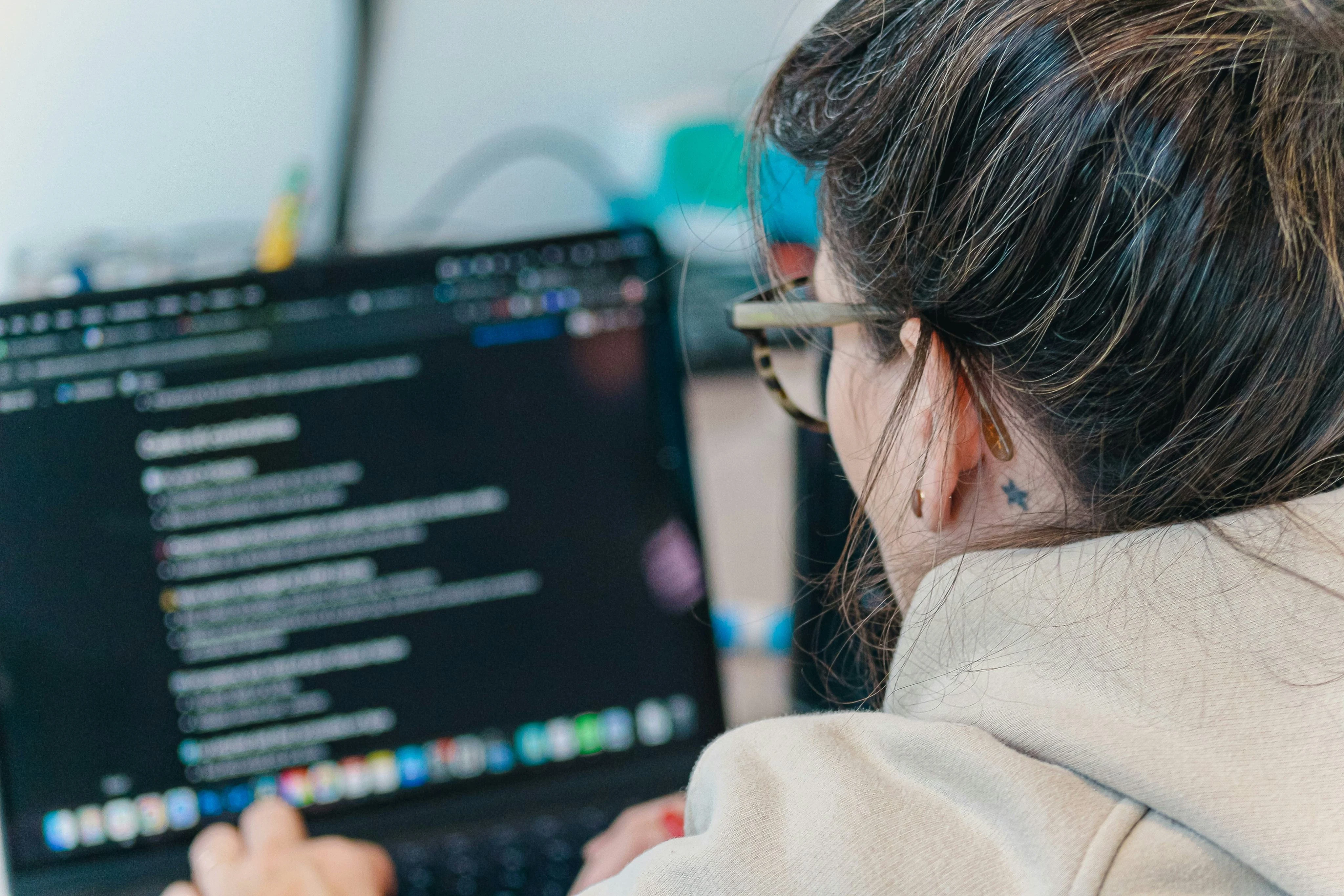 Learner exploring code and digital knowledge on a laptop