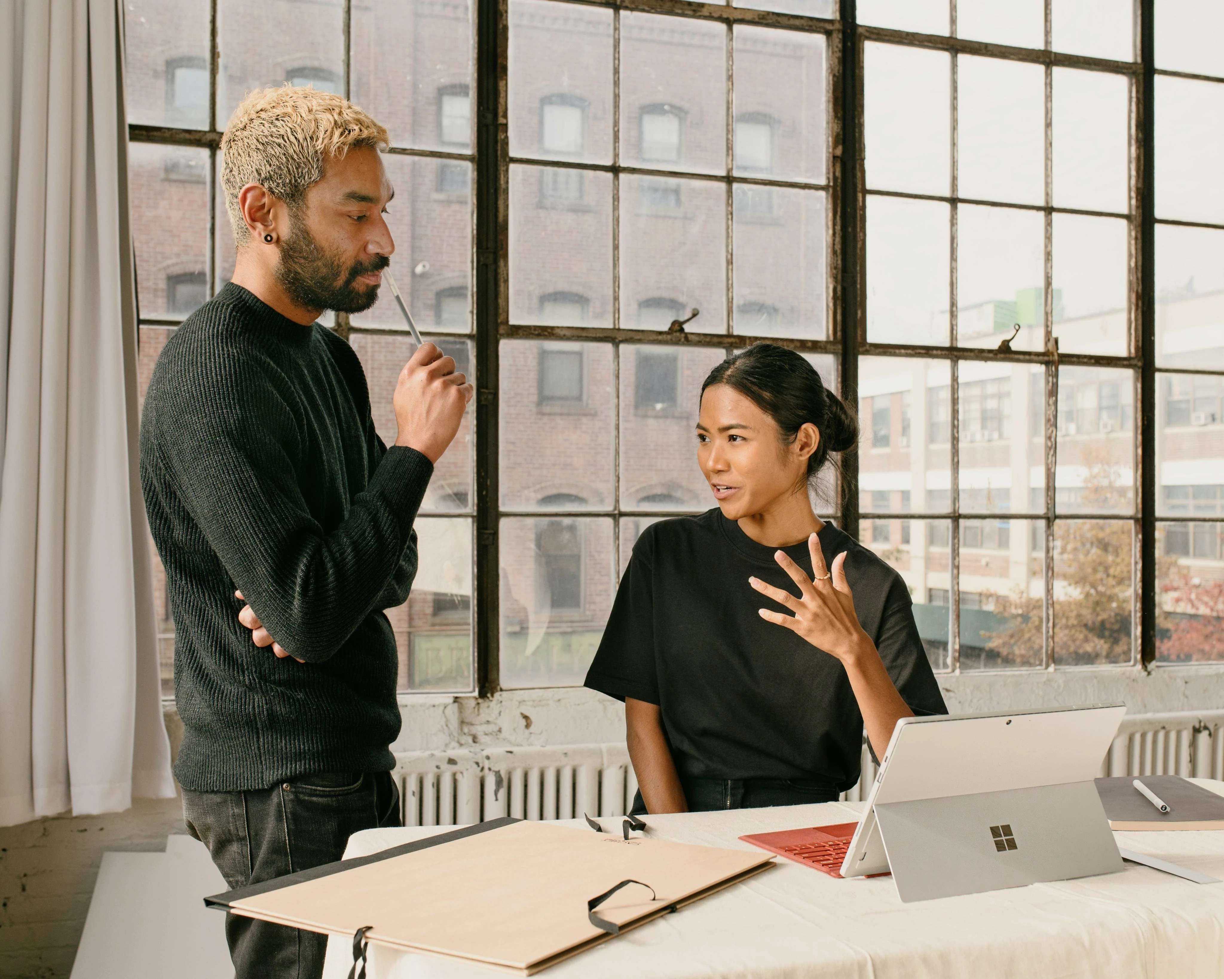 Mentor and learner discussing ideas in a modern workspace